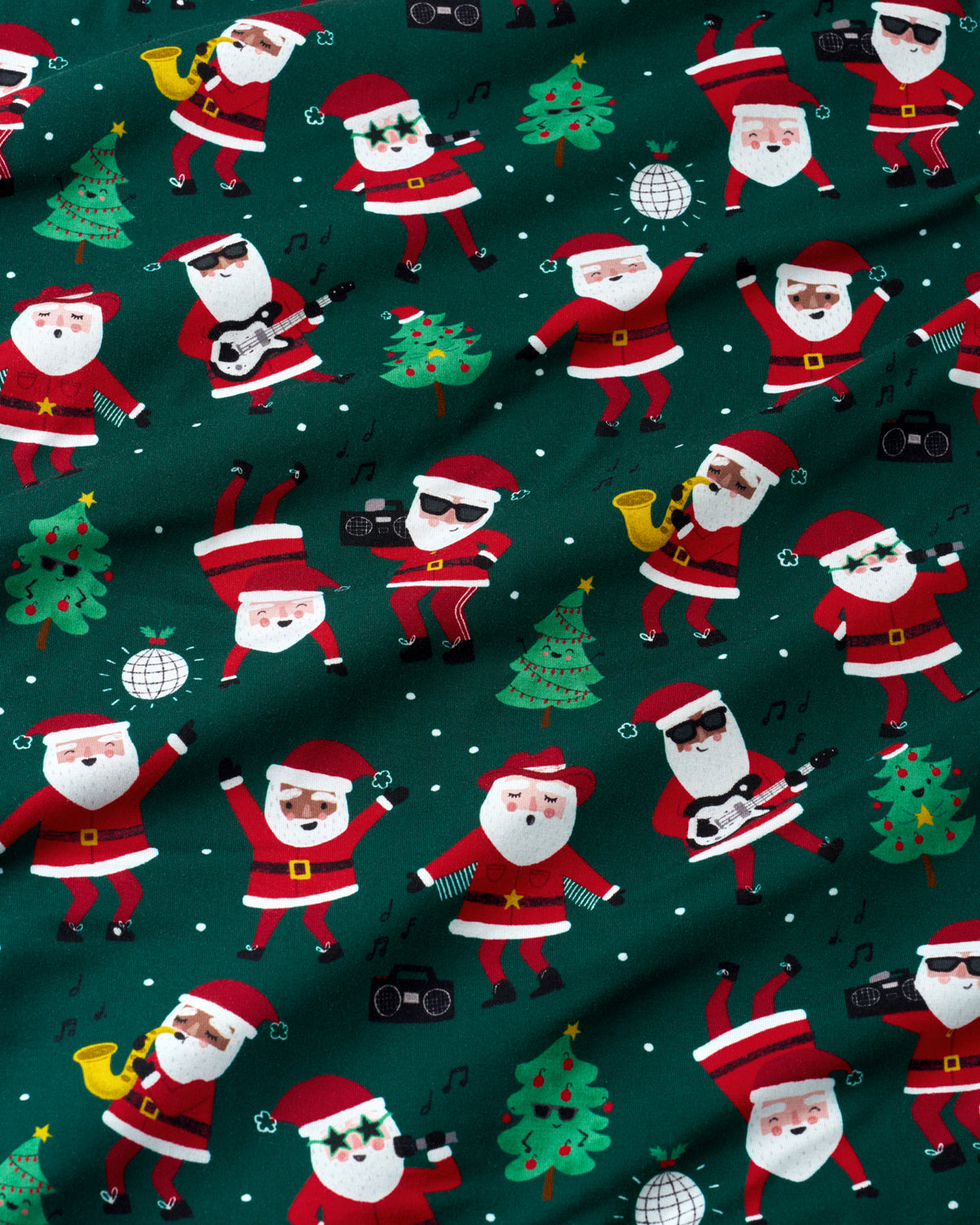 A close-up of a dark green fabric with a repeating pattern of cartoon Santa Claus figures playing music instruments, decorated Christmas trees, and small white musical notes.