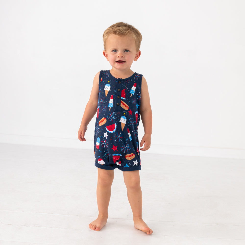 Standing child wearing the Snacks & Sparkles Henley Tank Romper