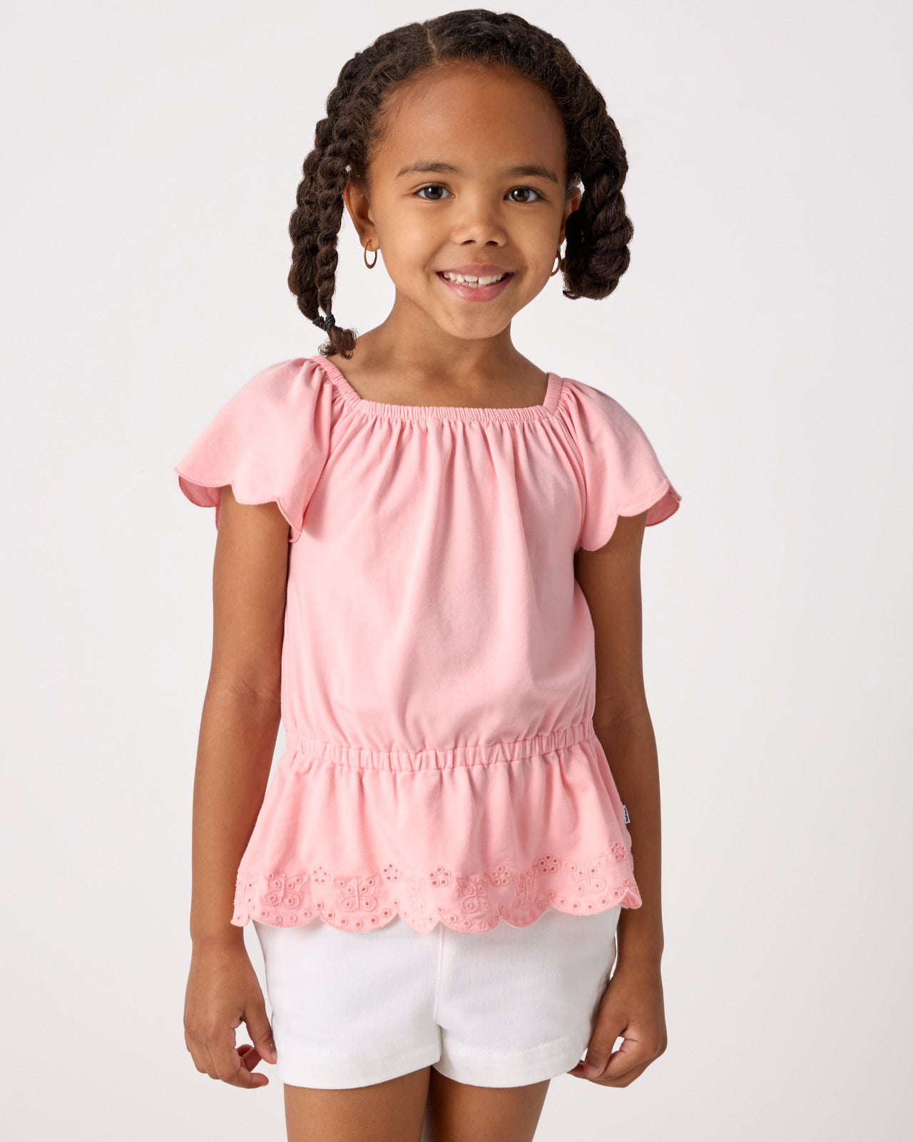 Girl wearing the Soft Coral Puff Sleeve Eyelet Top