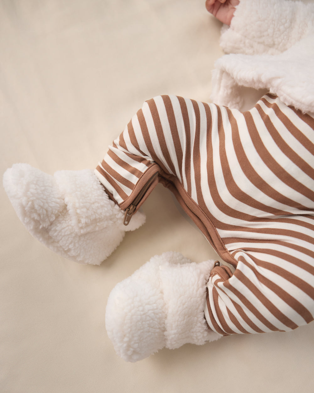 Close up of baby wearing the Soft White Sherpa Crossover Booties