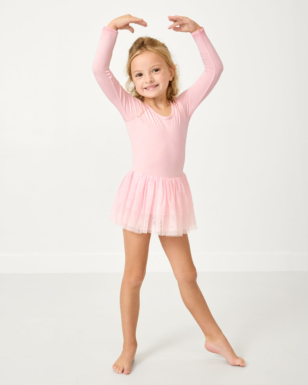 Posing girl wearing the Prima Pink Ballet Leotard Dress