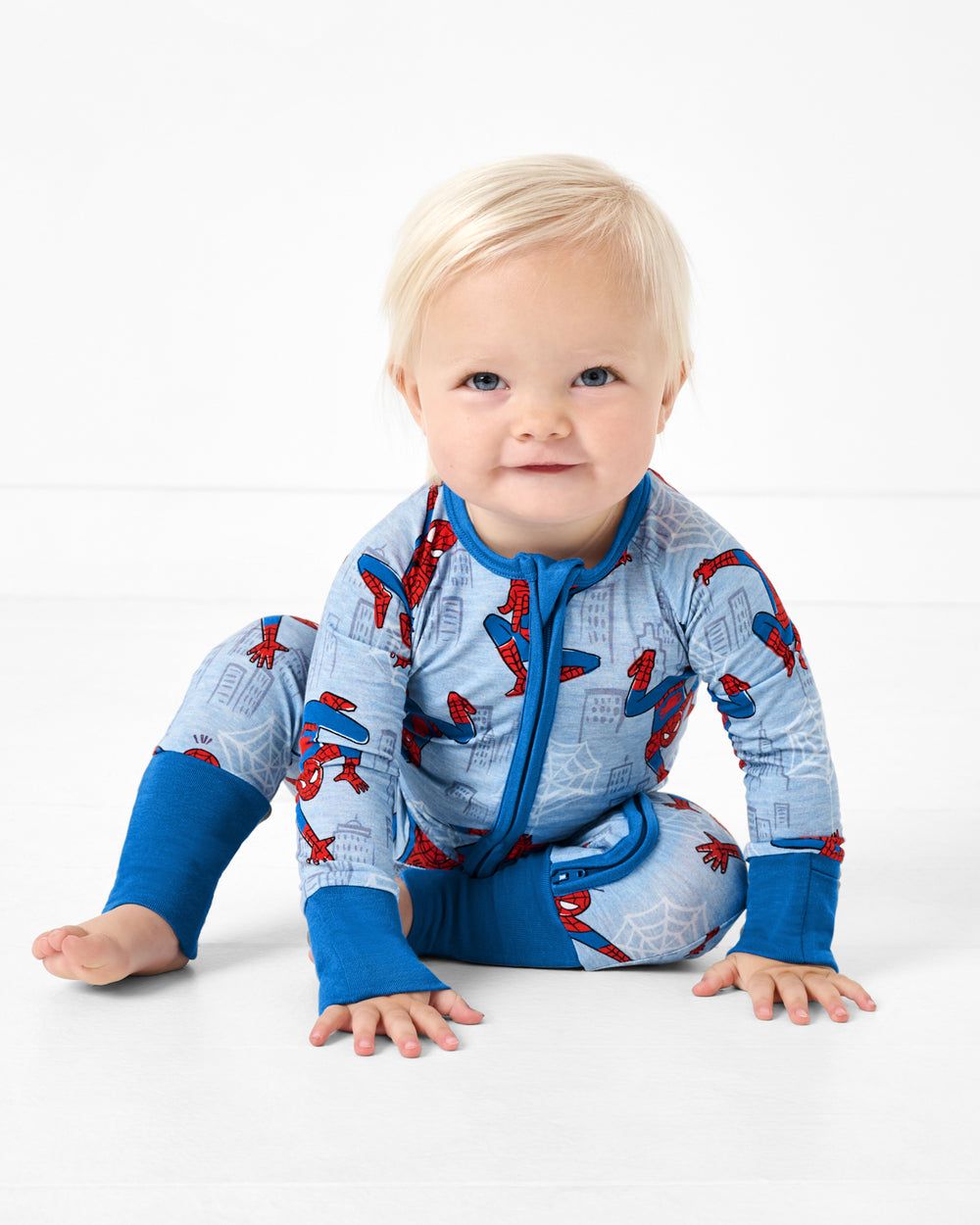 Sitting baby wearing the Spidey Sense Zippy