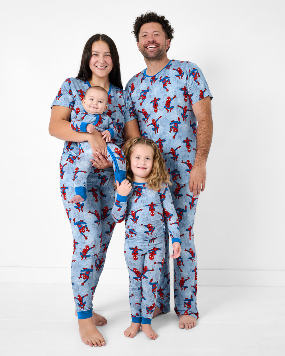Family of four wearing matching Spidey Sense PJs
