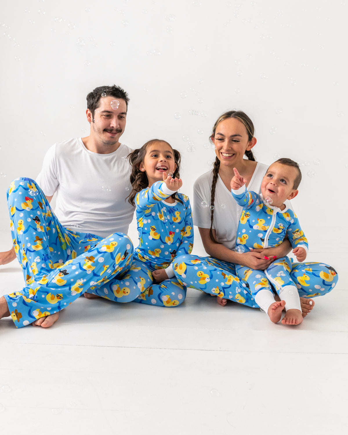 Family of four wearing matching Splish Splash bamboo pajamas