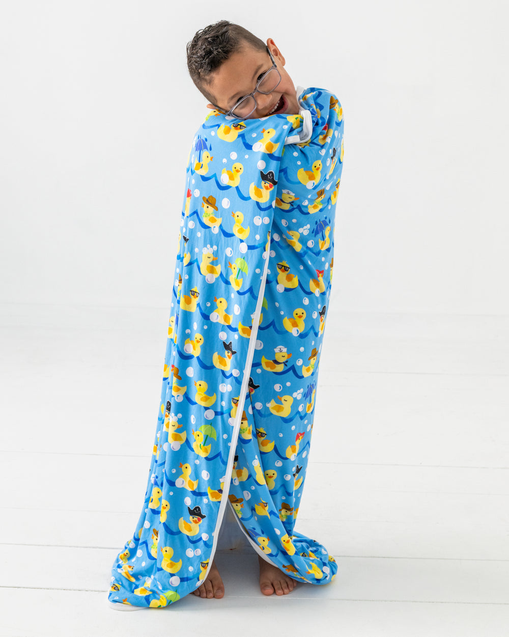 Boy wrapped in the Splish Splash Large Cloud Blanket®