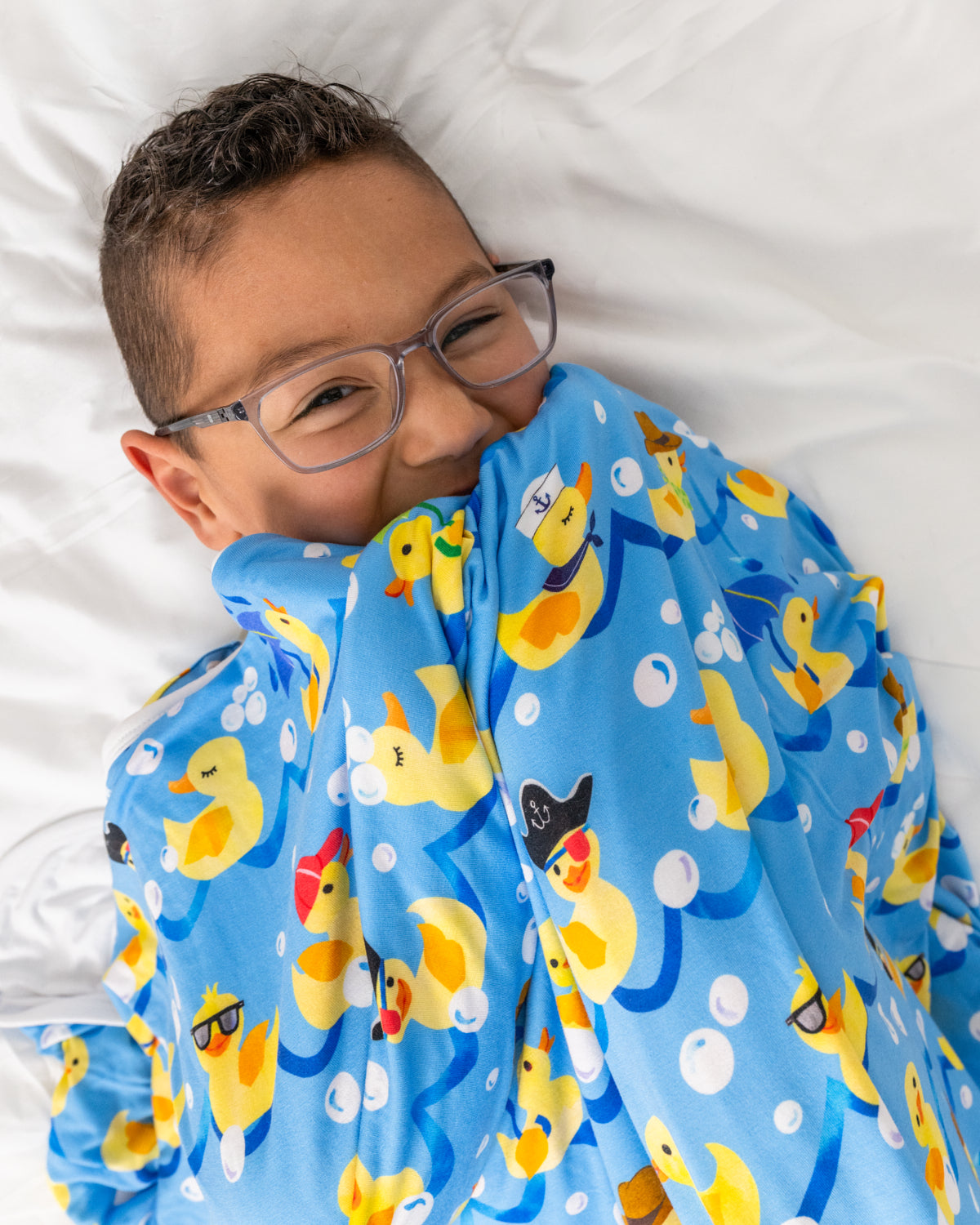 Boy laying with the Splish Splash Large Cloud Blanket®