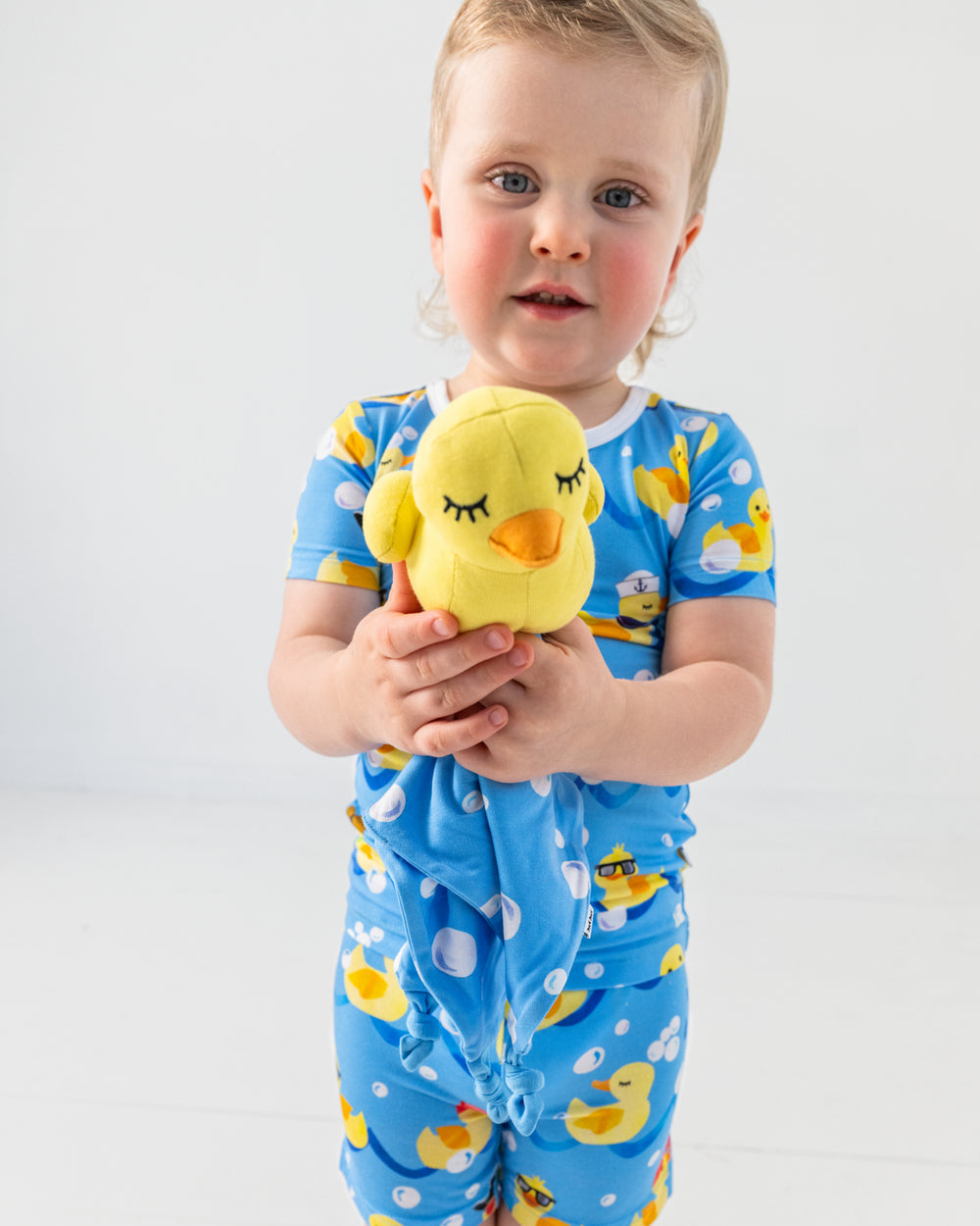Boy holding the Bubbles the Rubber Ducky Sleepyhead Lovey