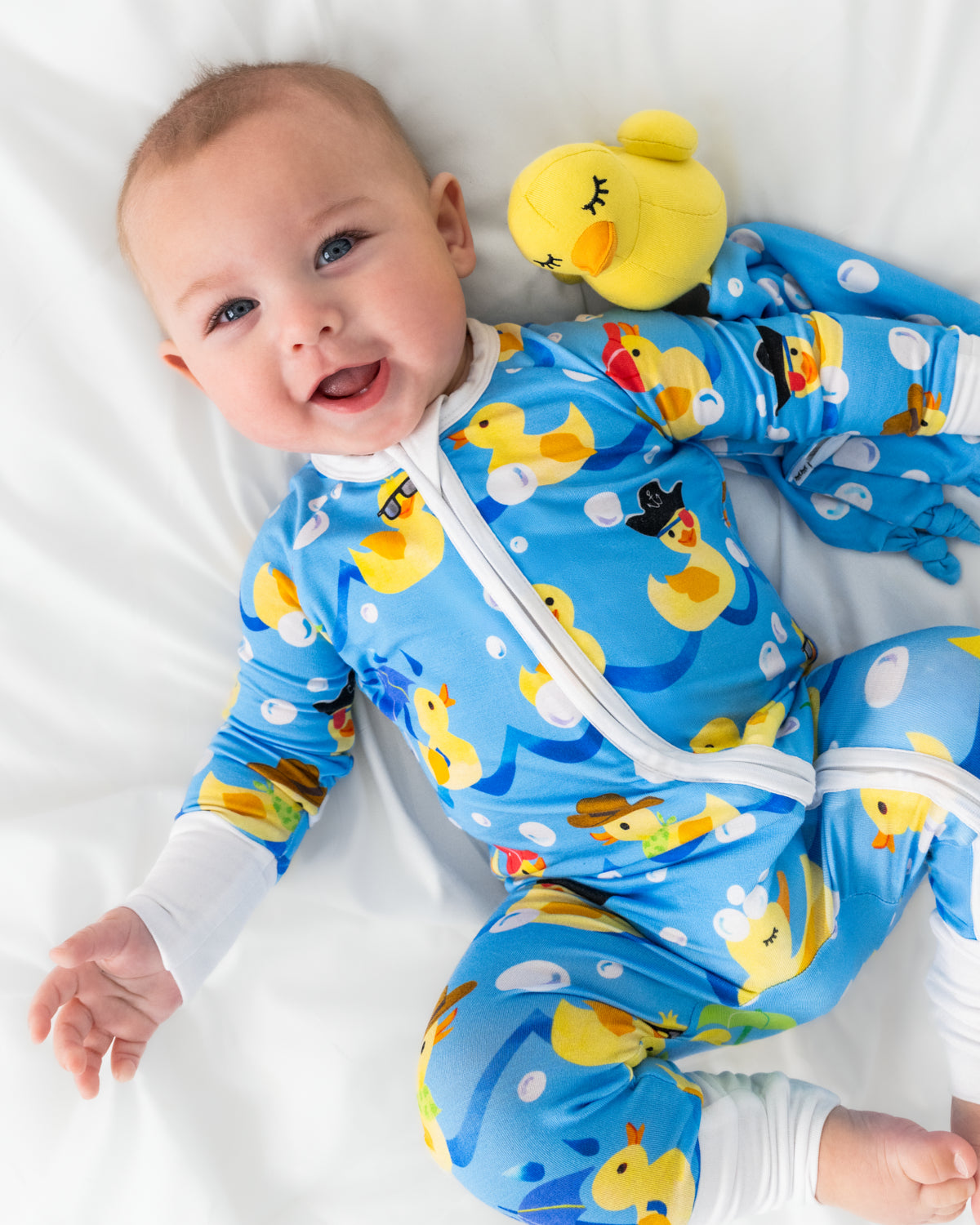 Baby laying with the Bubbles the Rubber Ducky Sleepyhead Lovey