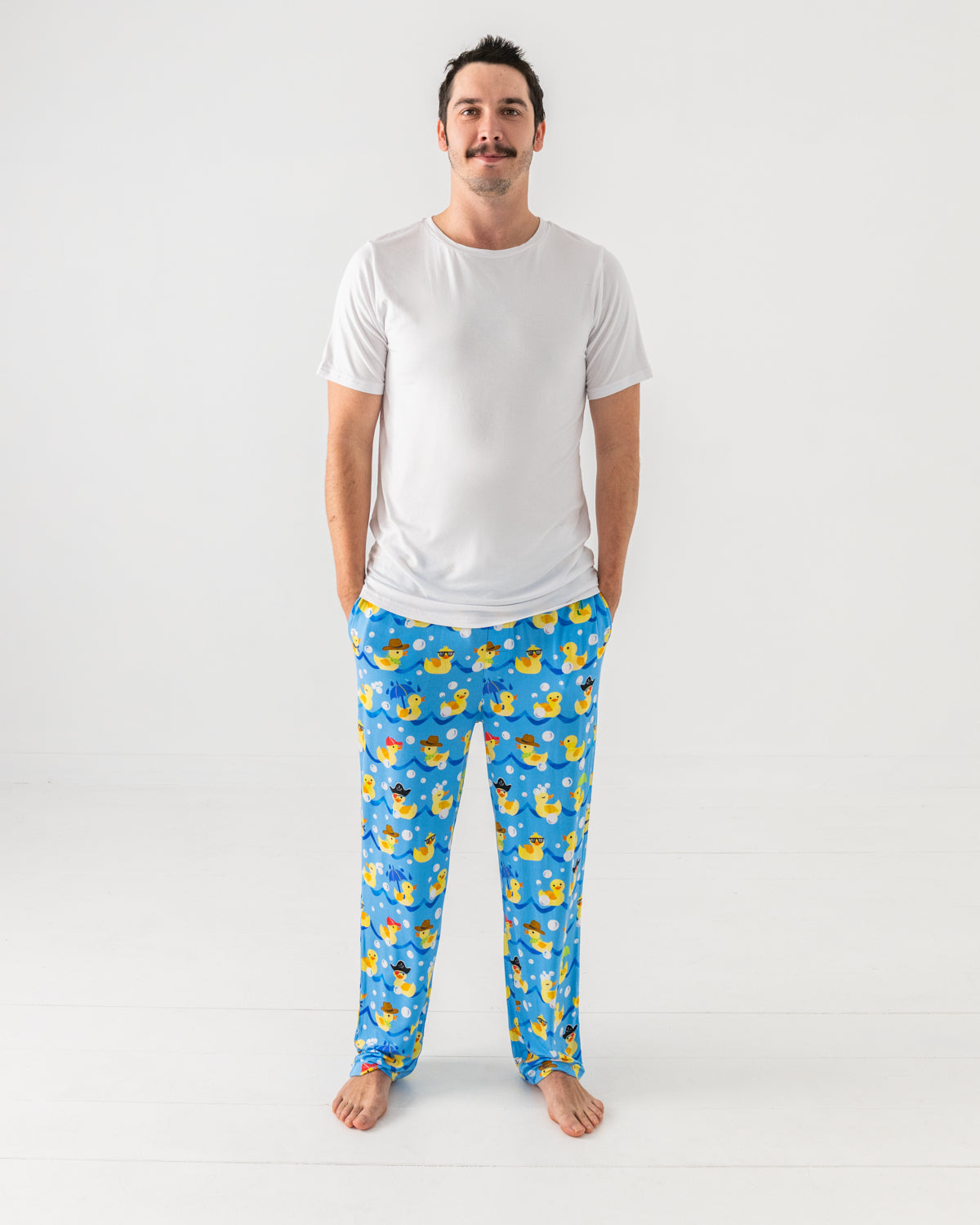 Standing man wearing the Splish Splash Men's Pajama Pants with a white pj top