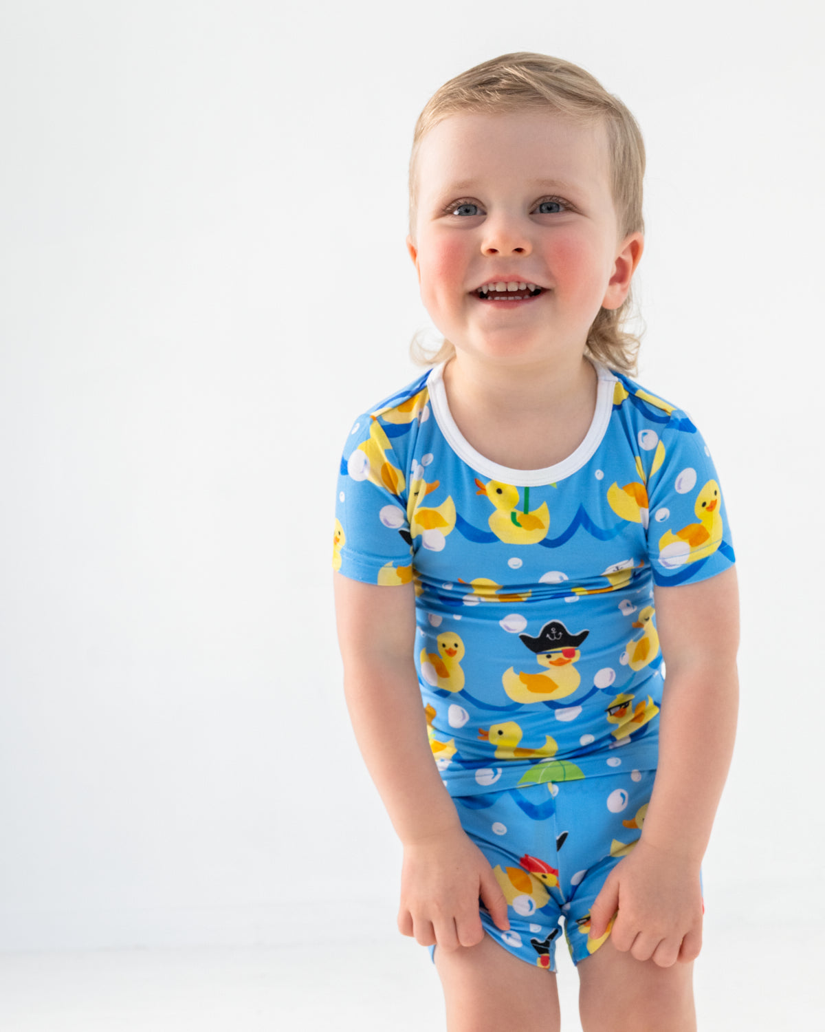 Close up of boy wearing the Splish Splash Two-Piece Short Sleeve & Shorts Pajama Set