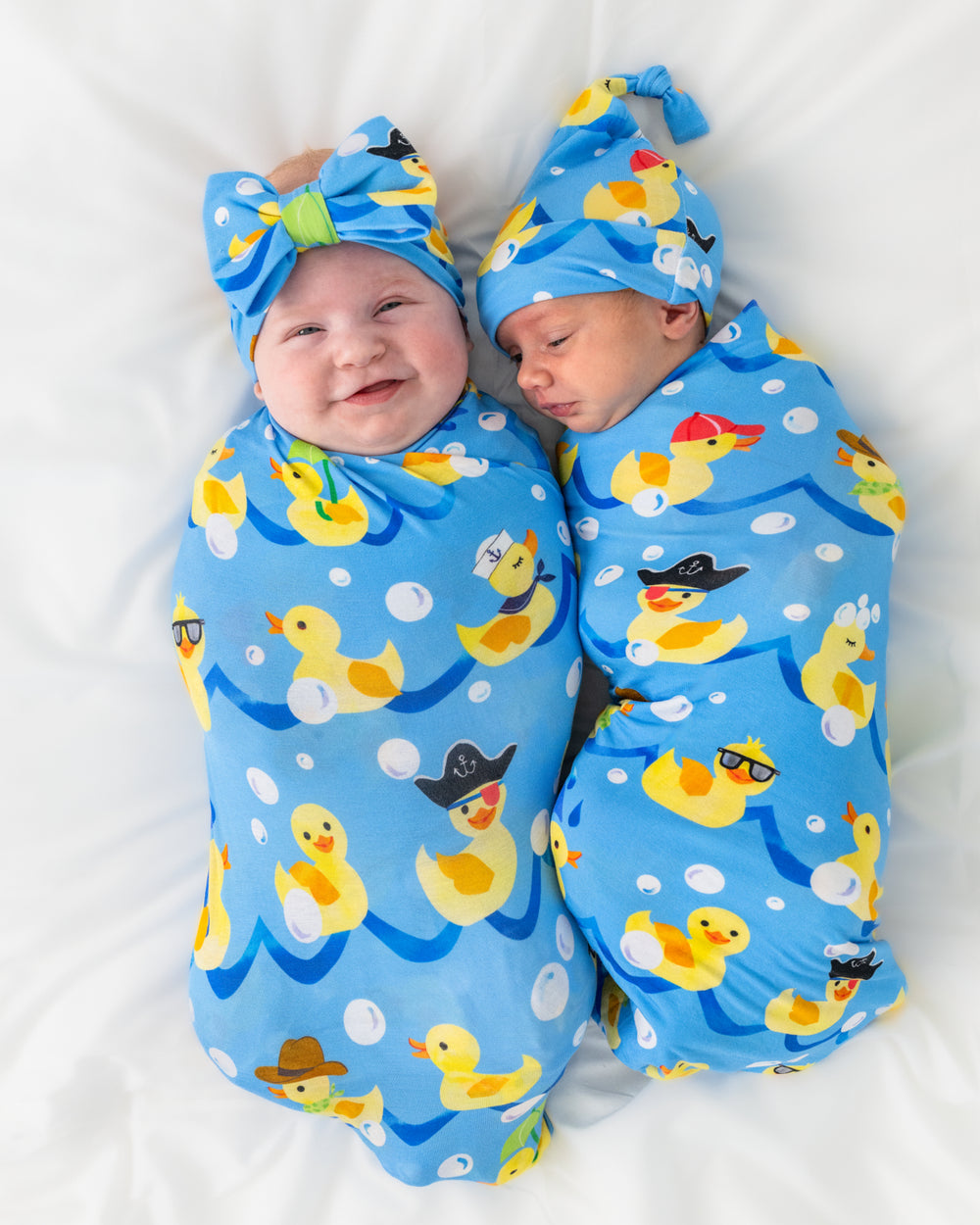 Aerial view of two babies wearing Splish Splash Swaddle Sets