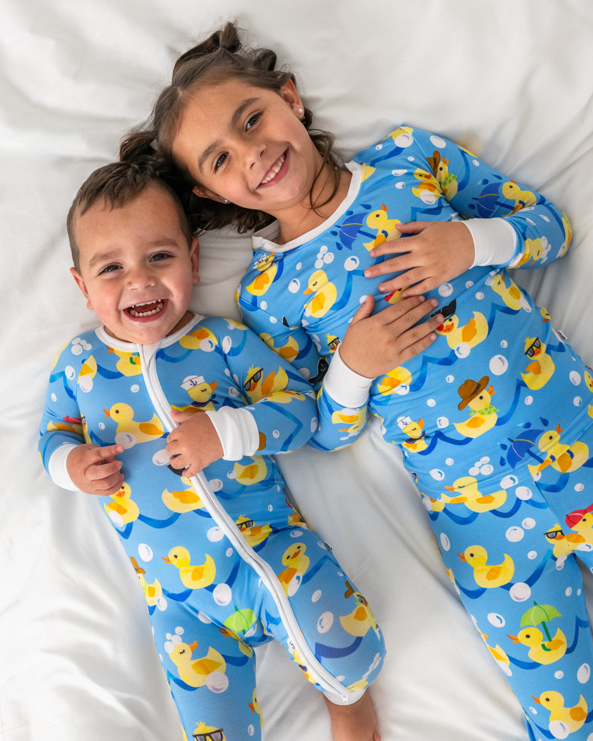 Aerial view of two kids wearing matching Splish Splash pajamas