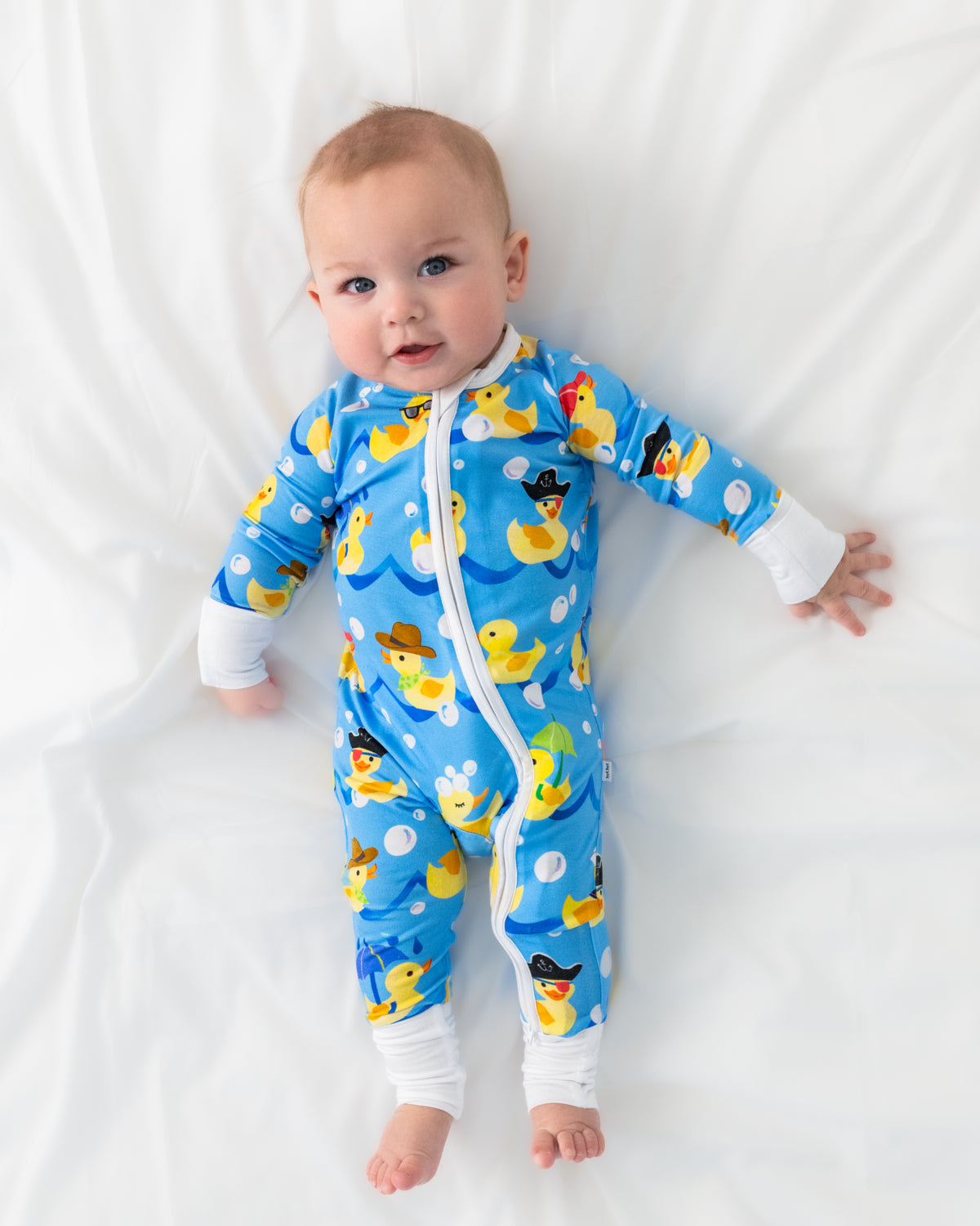 Aerial view of baby wearing the Splish Splash Bamboo Zipper pajamas