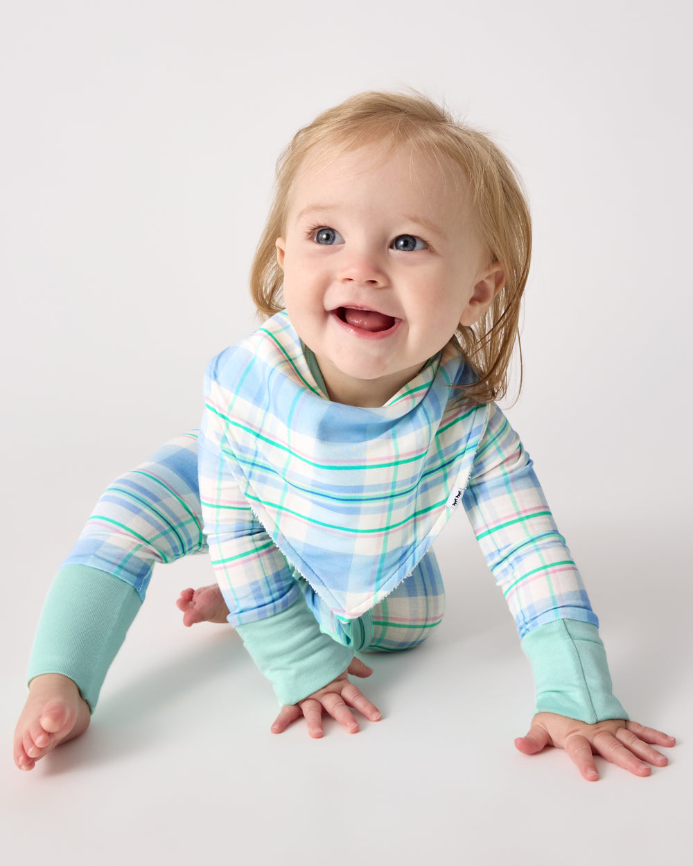 Crawling baby wearing the Springtime Plaid Bandana Bib