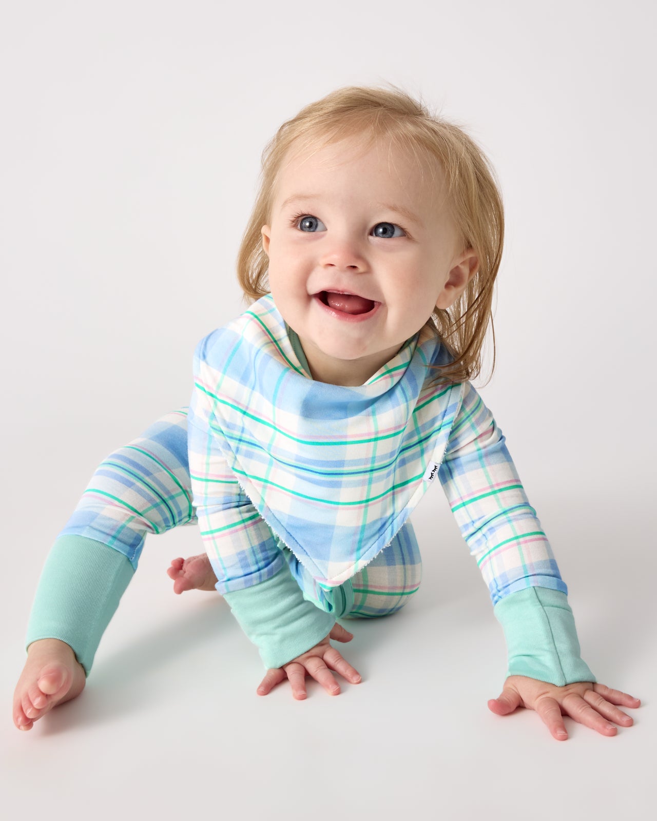 Crawling baby wearing the Springtime Plaid Bandana Bib