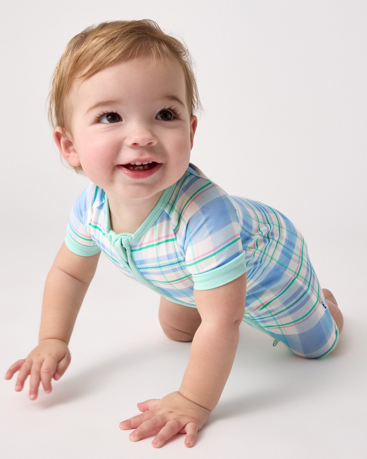 Crawling baby wearing the Springtime Plaid Shorty Zippy