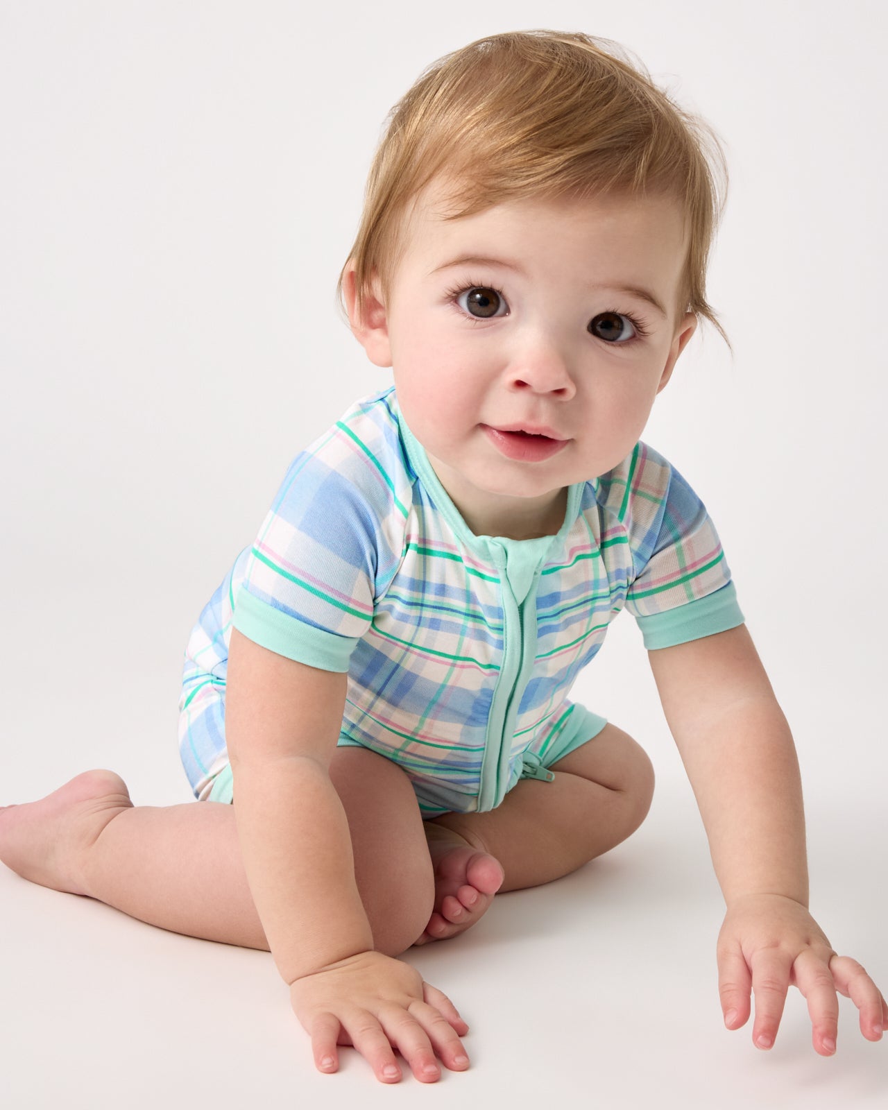 Sitting baby wearing the Springtime Plaid Shorty Zipper Pajama