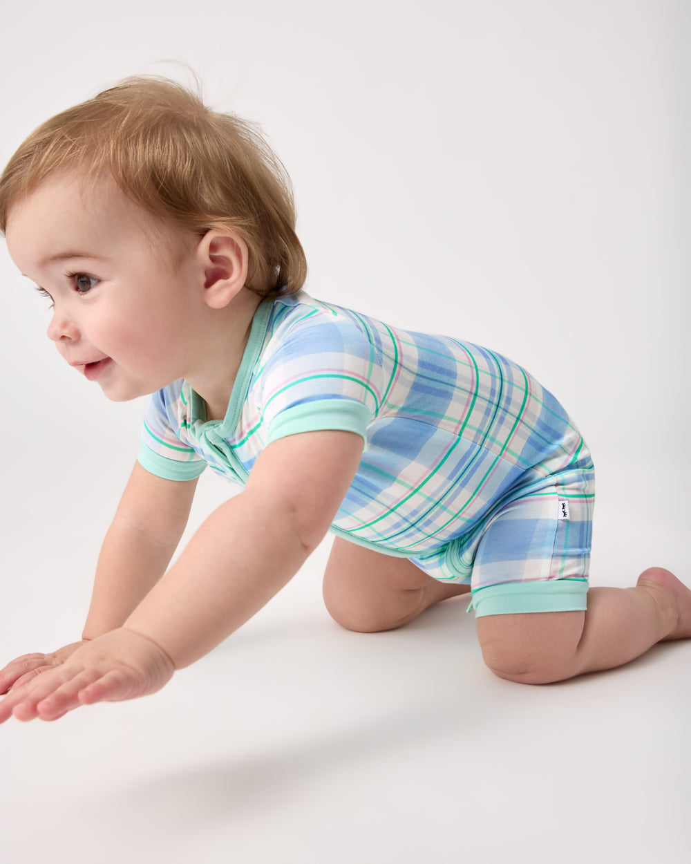 Child in motion wearing the Springtime Plaid Shorty Zippy