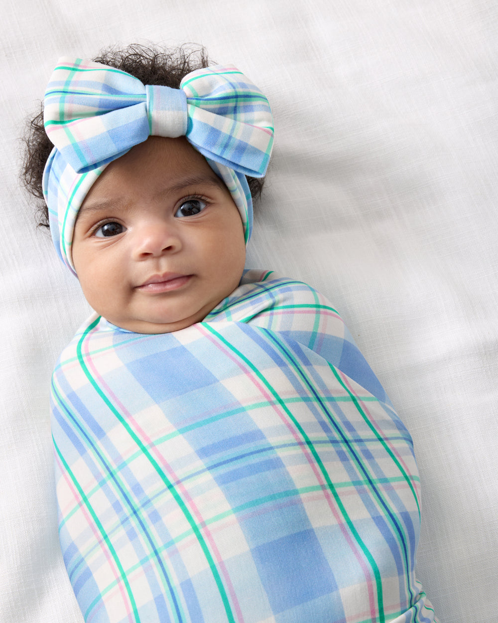 Close up of the Springtime Plaid Swaddle & Luxe Bow Headband Set
