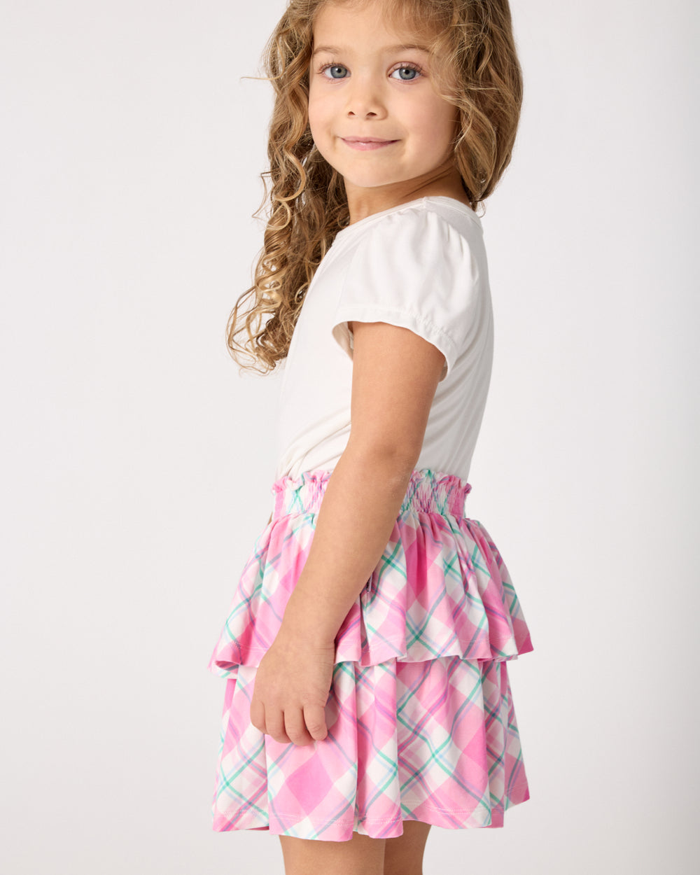 Side view of girl wearing the Springtime Plaid Tiered Skort