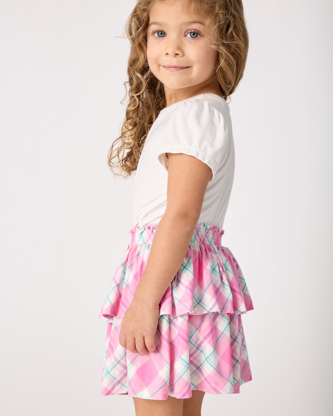 Side view of girl wearing the Springtime Plaid Tiered Skort