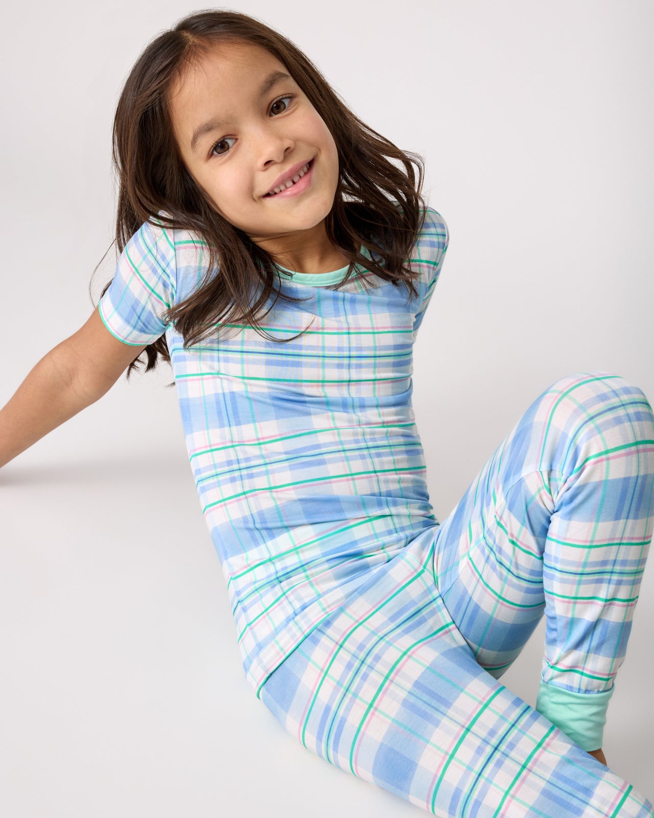 Sitting girl wearing the Springtime Plaid Two-Piece Short Sleeve Pajama Set
