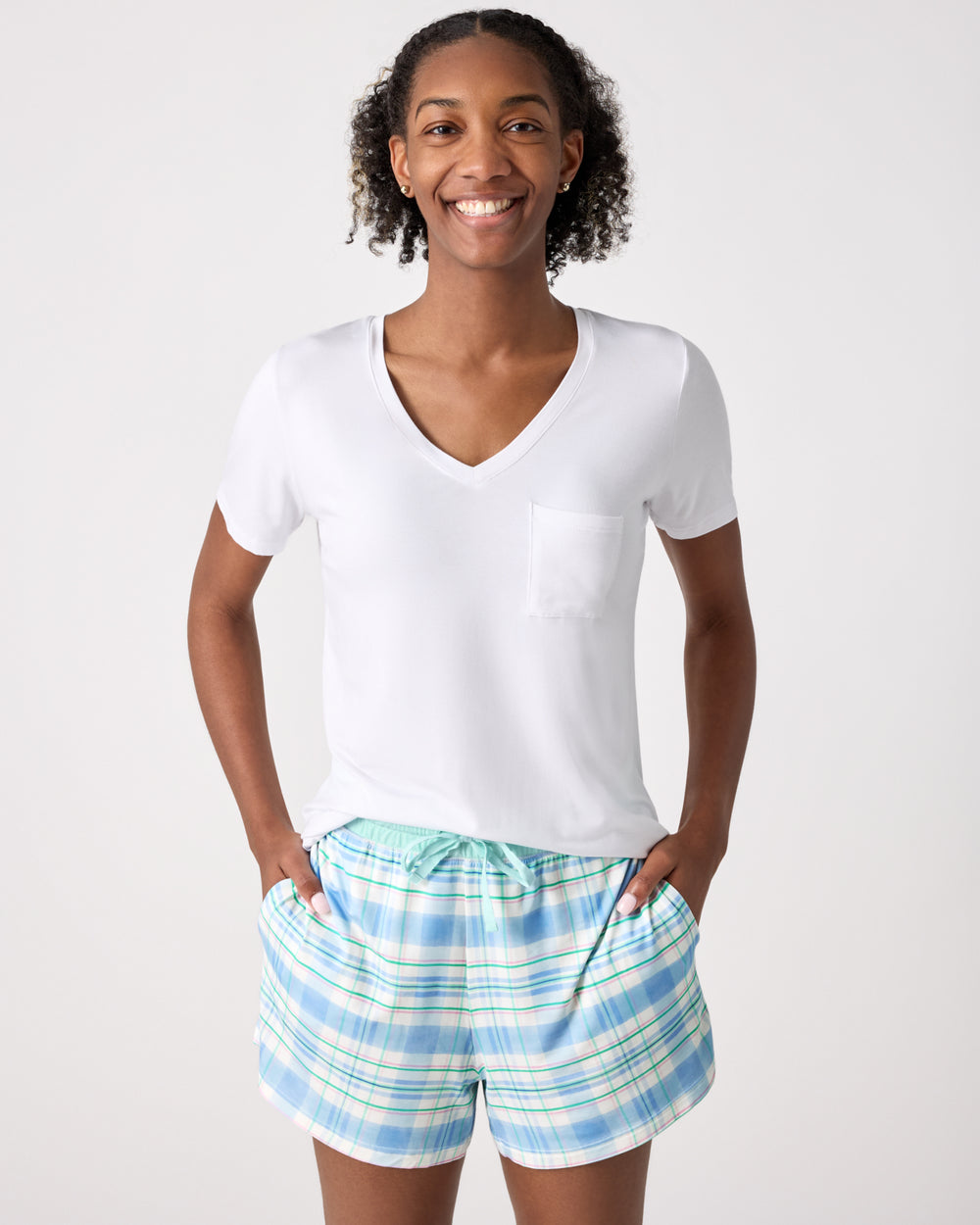 Woman wearing the Springtime Plaid Women's Pajama Shorts and White Shirt