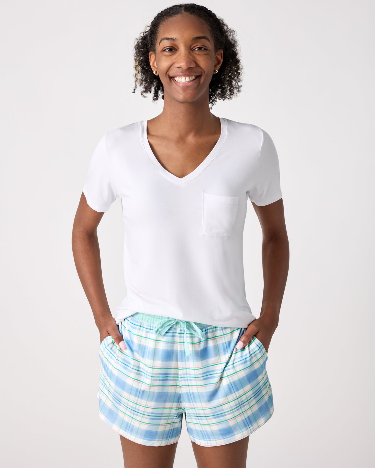 Woman wearing the Springtime Plaid Women's Pajama Shorts and White Shirt