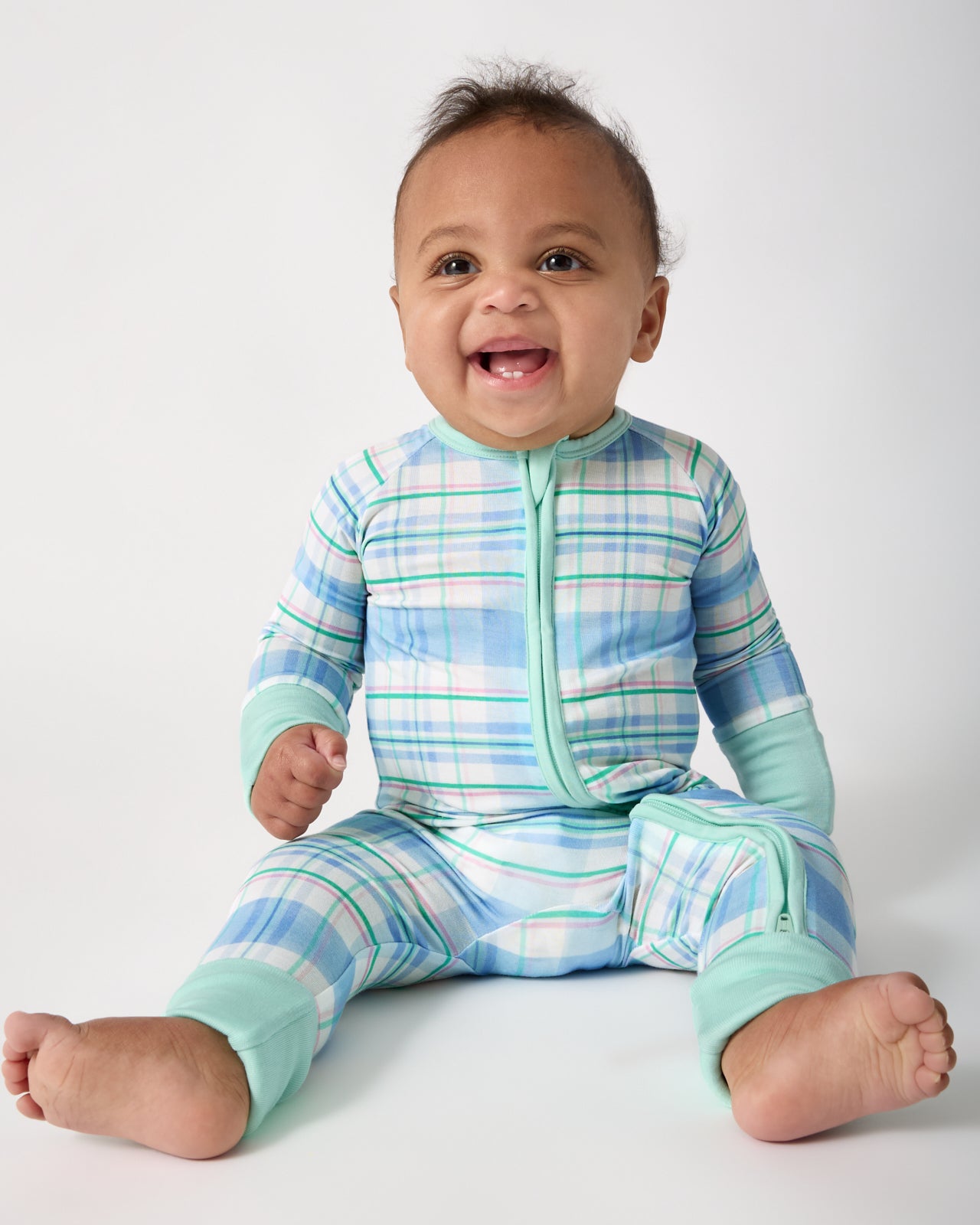 Sitting baby wearing the Springtime Plaid Zippy