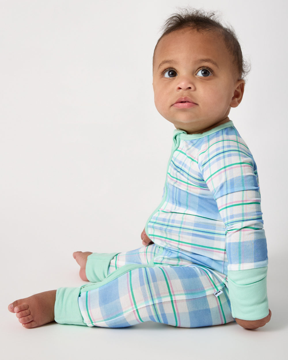Side view of baby wearing the Springtime Plaid Double Zipper Pajama