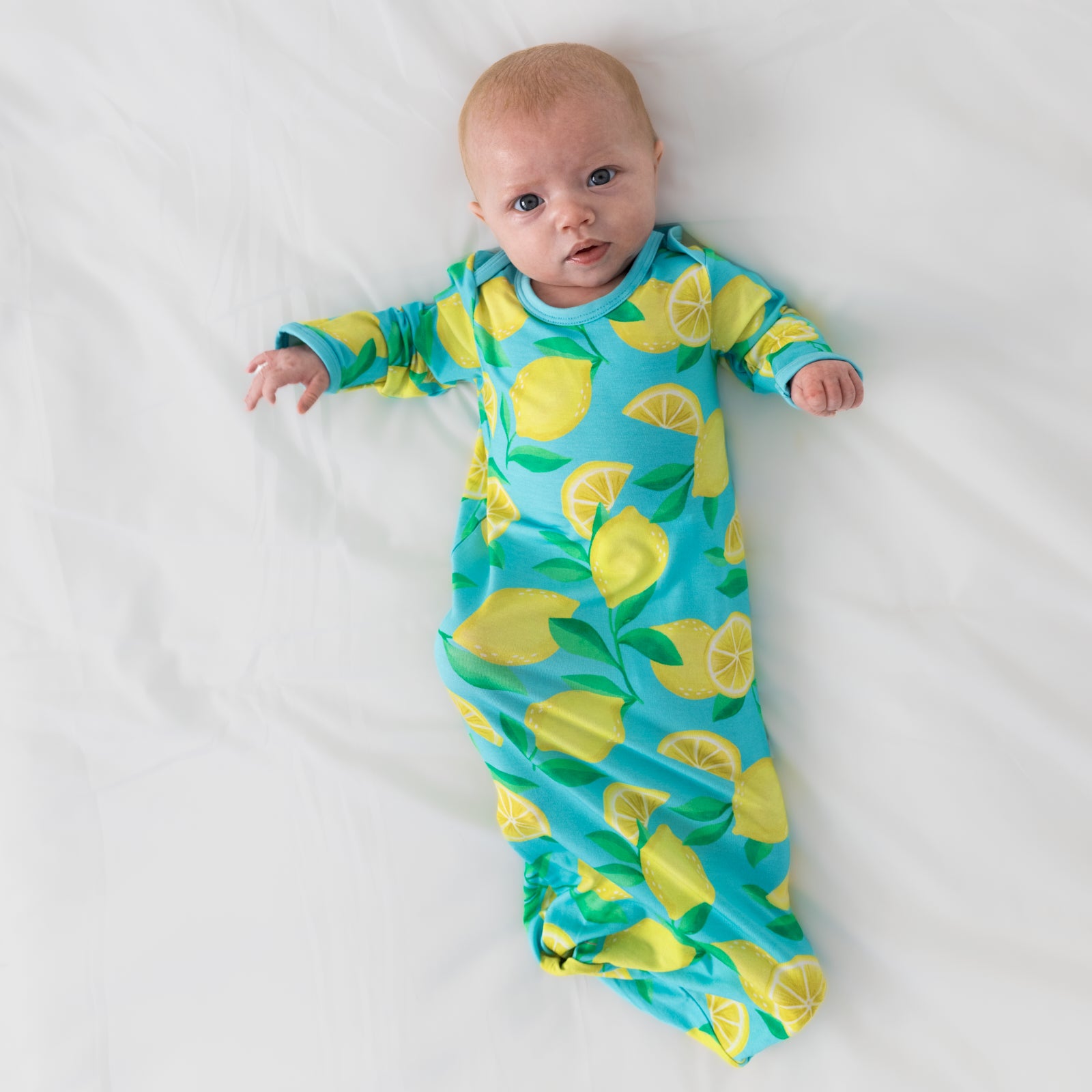 Aerial view of child wearing the Blue Sunny Citrus Infant Gown