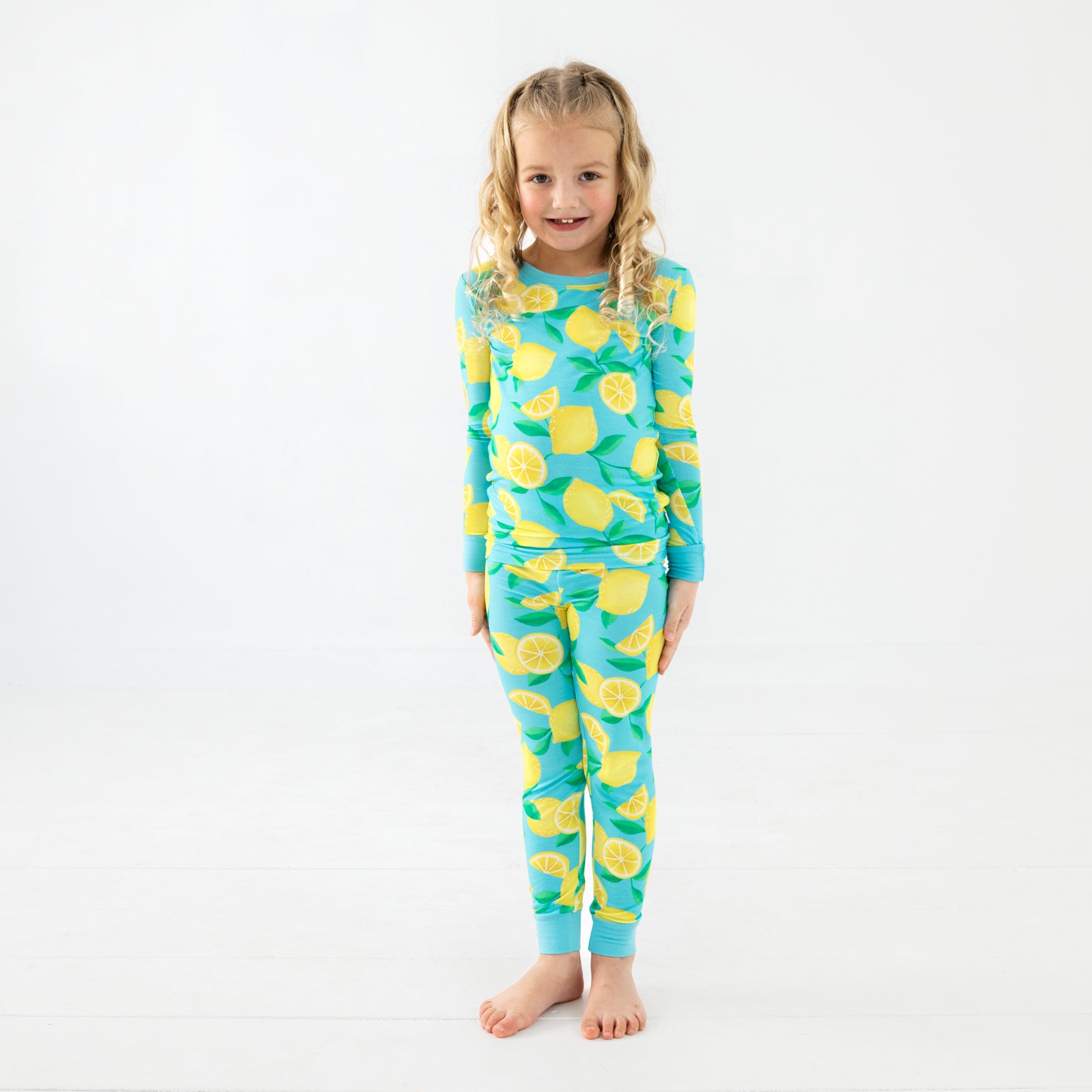 Standing girl wearing the Blue Sunny Citrus Two-Piece Pajama Set