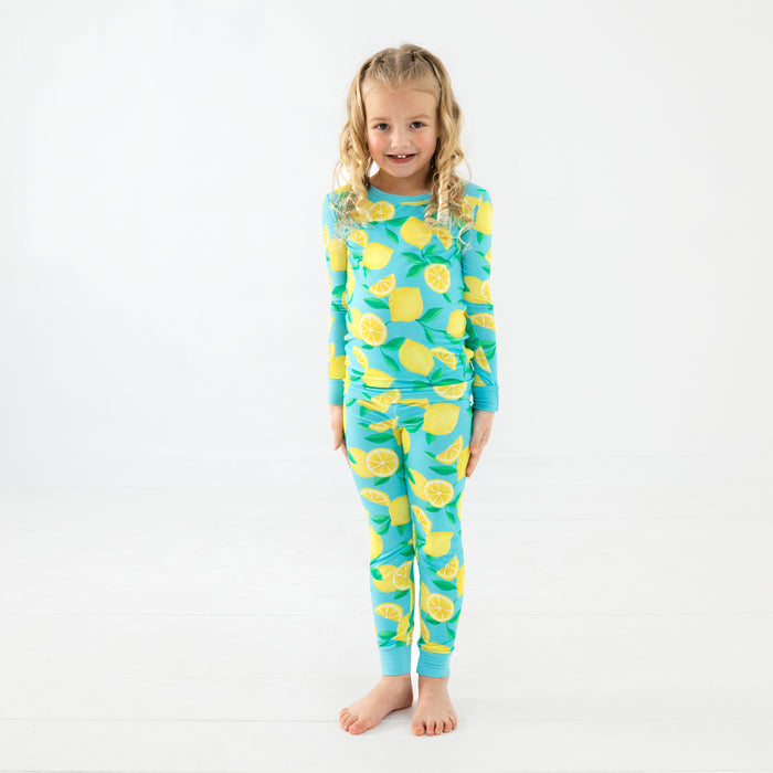 Standing girl wearing the Blue Sunny Citrus Two-Piece Pajama Set