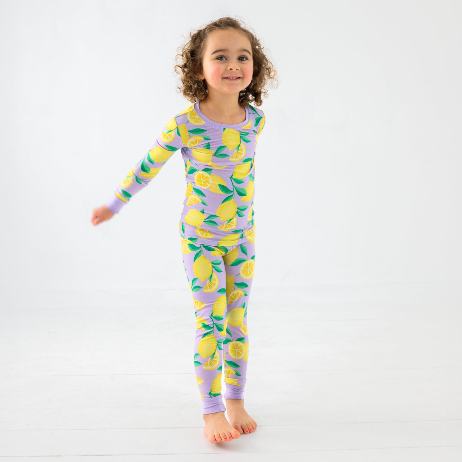 Standing chilld wearing the Lavender Sunny Citrus Two-Piece Pajama Set