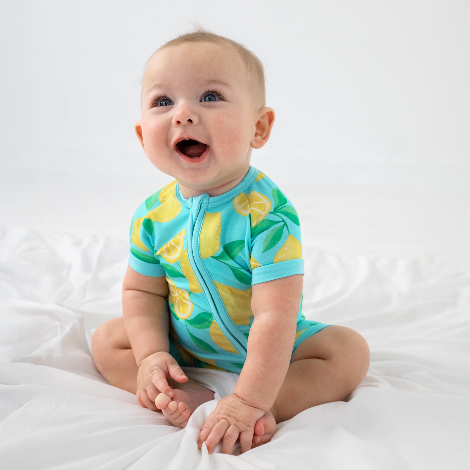 Sitting child wearing the Blue Sunny Citrus Shorty Zippy