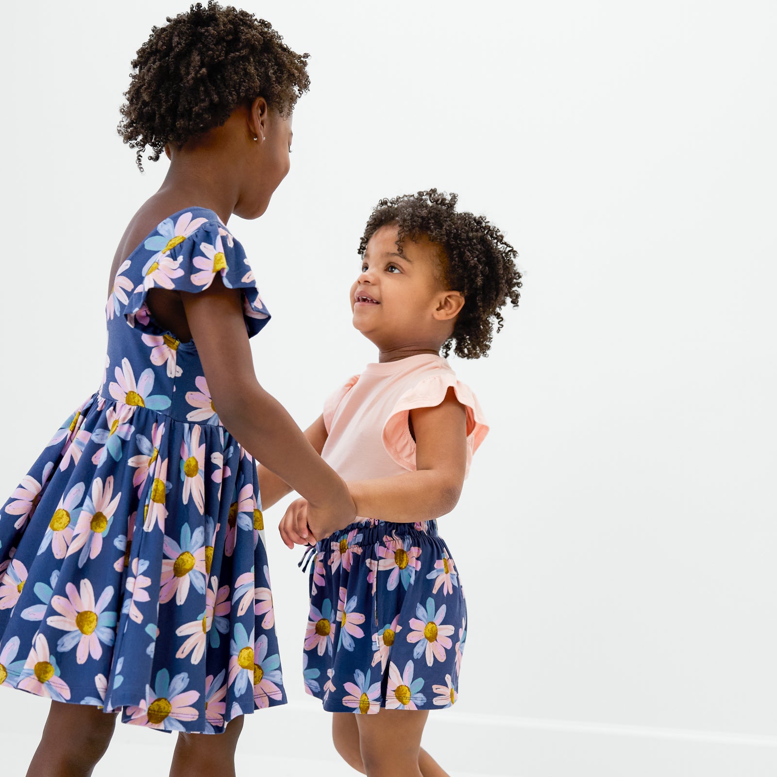 Two children wearing matching Daisy Blooms bamboo styles