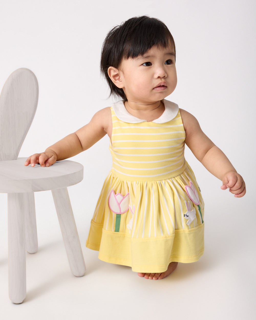 Baby wearing the Sunny Tulip Collar Skater Dress with Bloomer