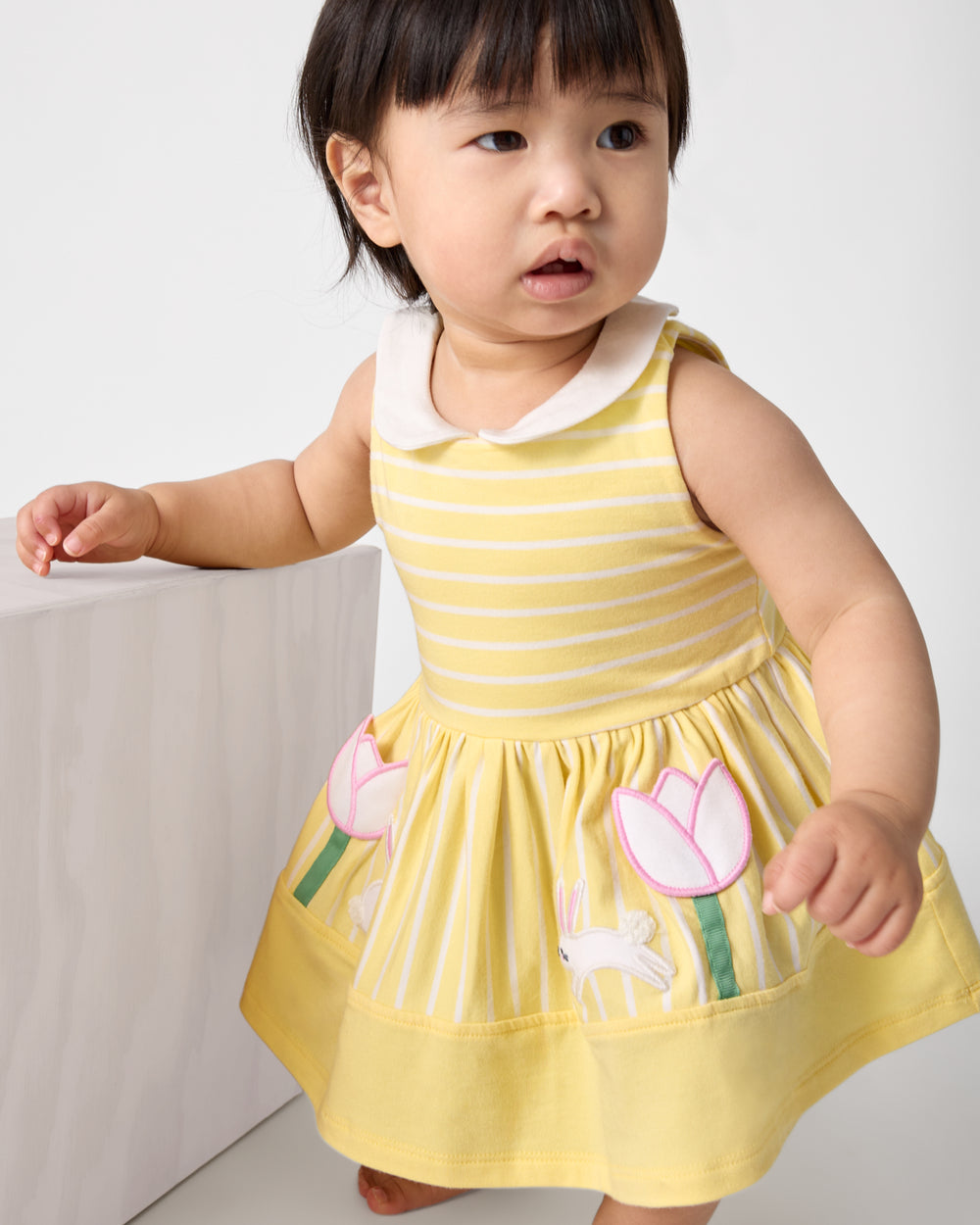 Baby girl wearing the Sunny Tulip Collar Skater Dress with Bloomer