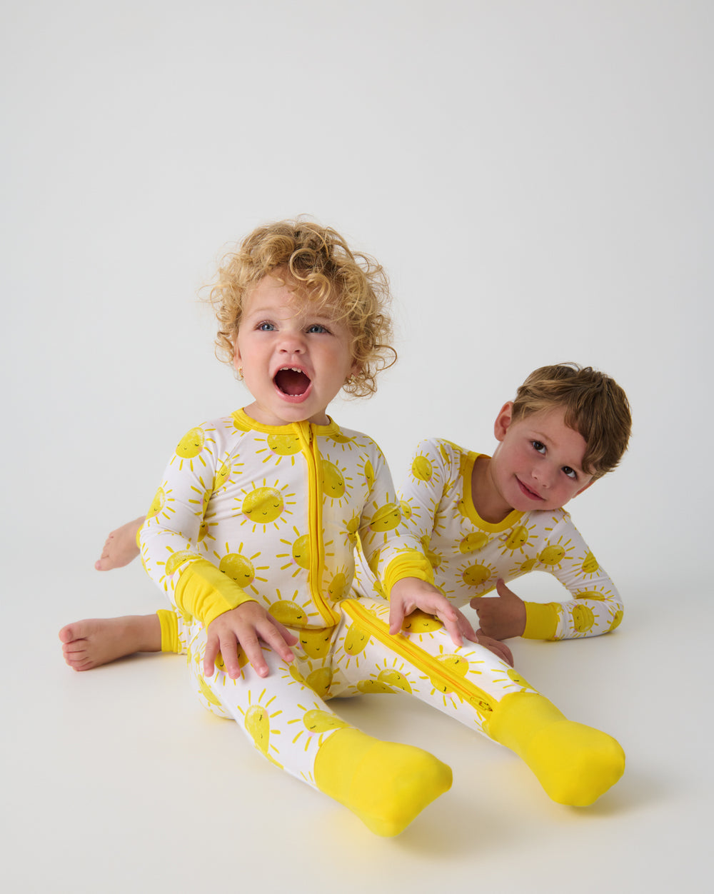 Two kids wearing matching Sunshine Pajamas