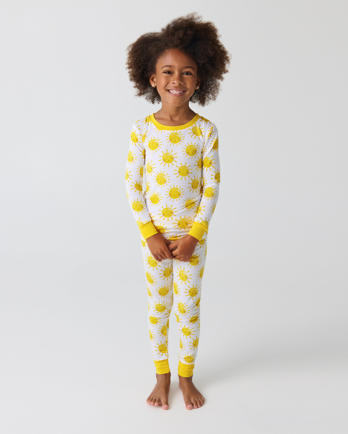 Standing child wearing the Sunshine Two-Piece Pajama Set