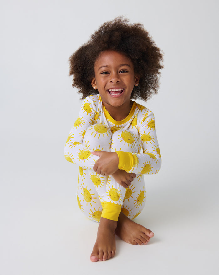 Sitting girl wearing the Sunshine Two-Piece Pajama Set