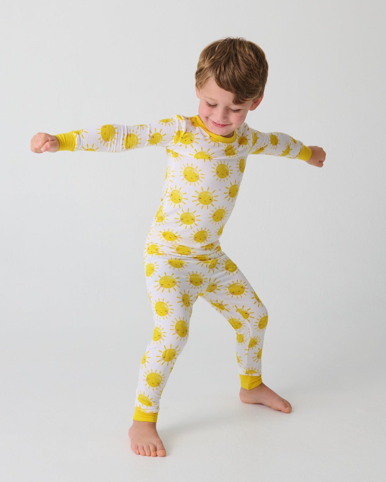 Posing boy wearing the Sunshine Two-Piece Pajama Set