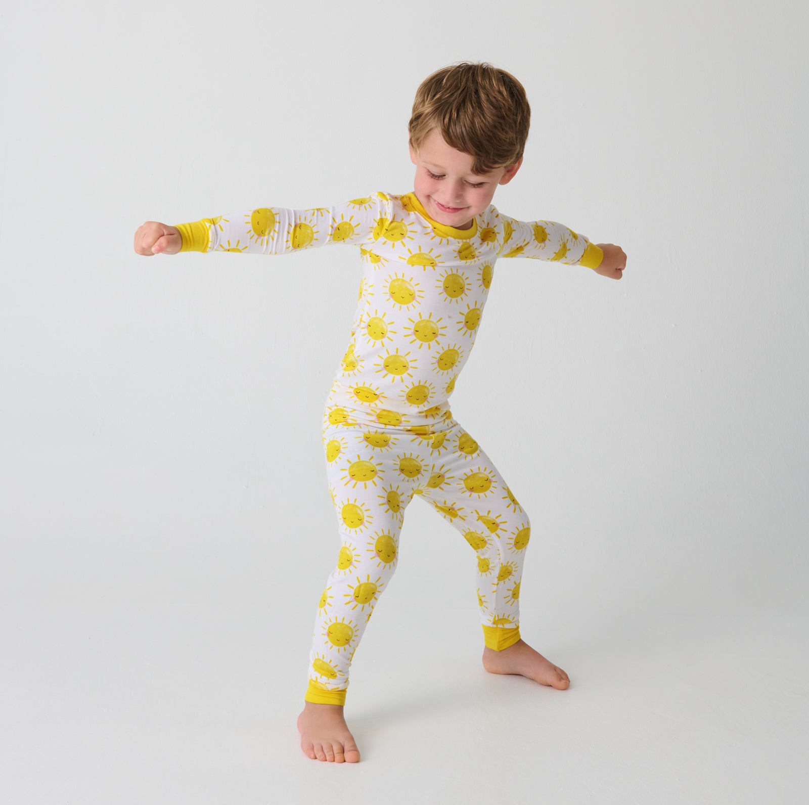 Posing boy wearing the Sunshine Two-Piece Pajama Set