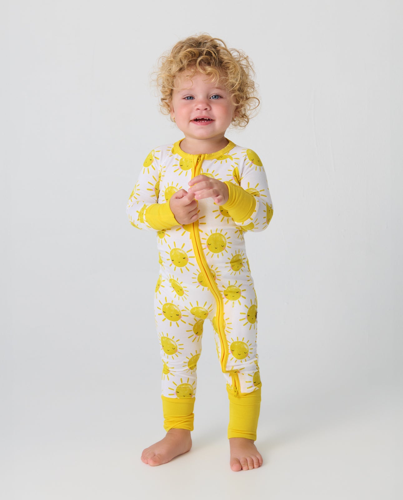 Standing toddler wearing the Sunshine Zippy