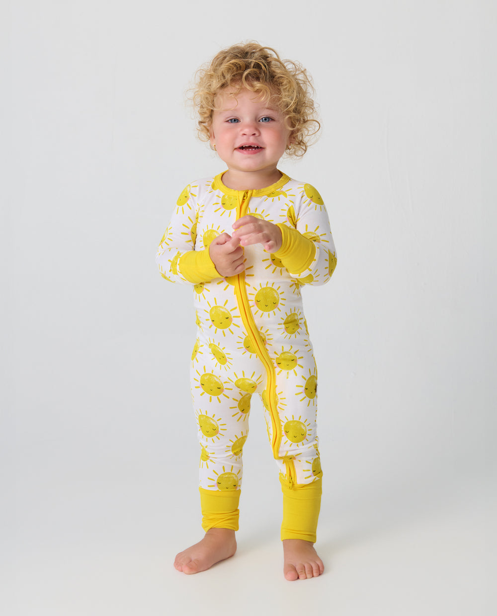 Standing toddler wearing the Sunshine Zippy