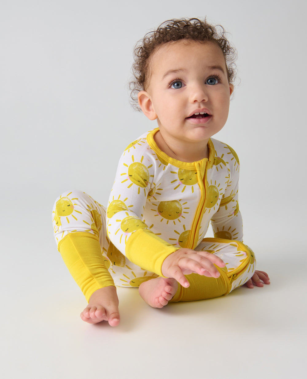 Sitting baby wearing the Sunshine Zippy