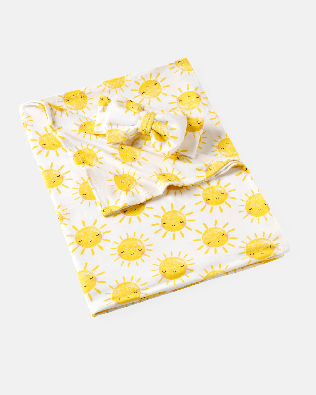 Flat lay of the Sunshine Swaddle & Luxe Bow Headband Set