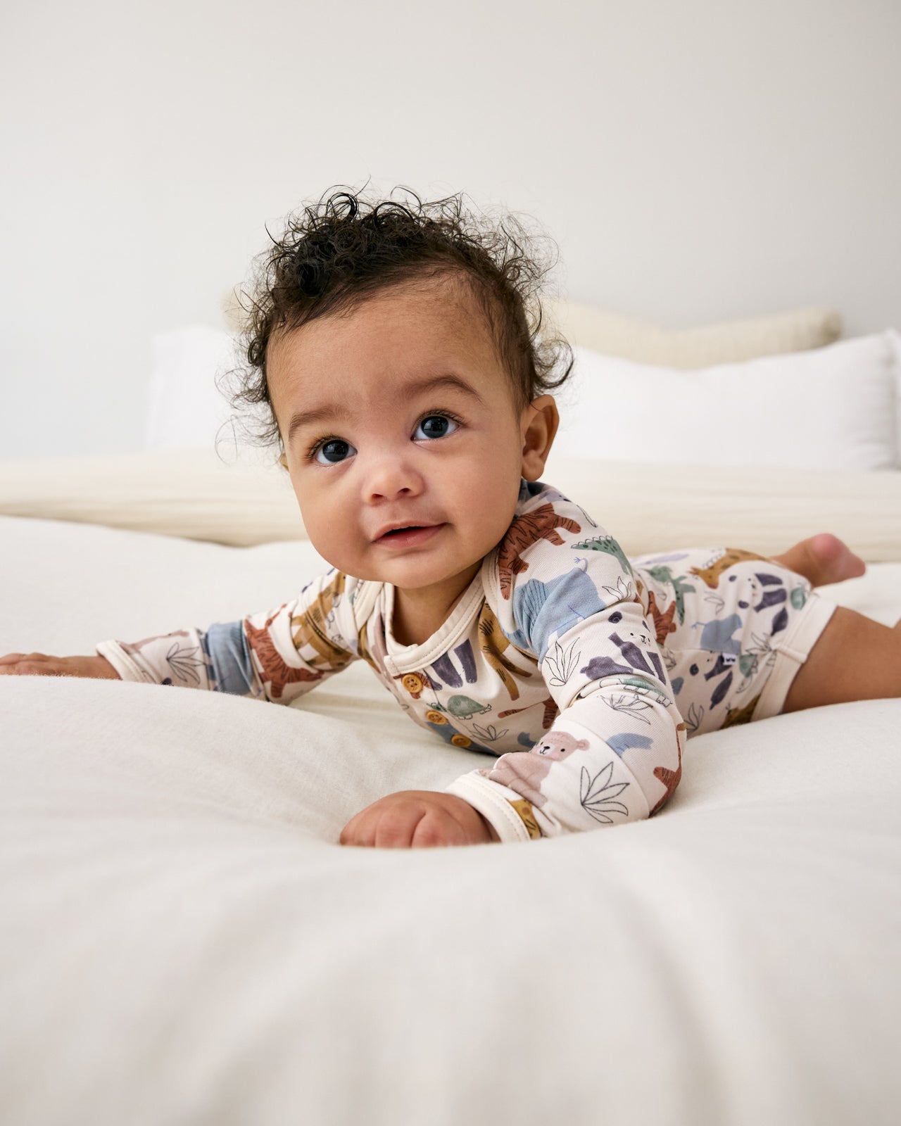 Baby laying on tummy wearing the Sweet Safari Henley Bodysuit