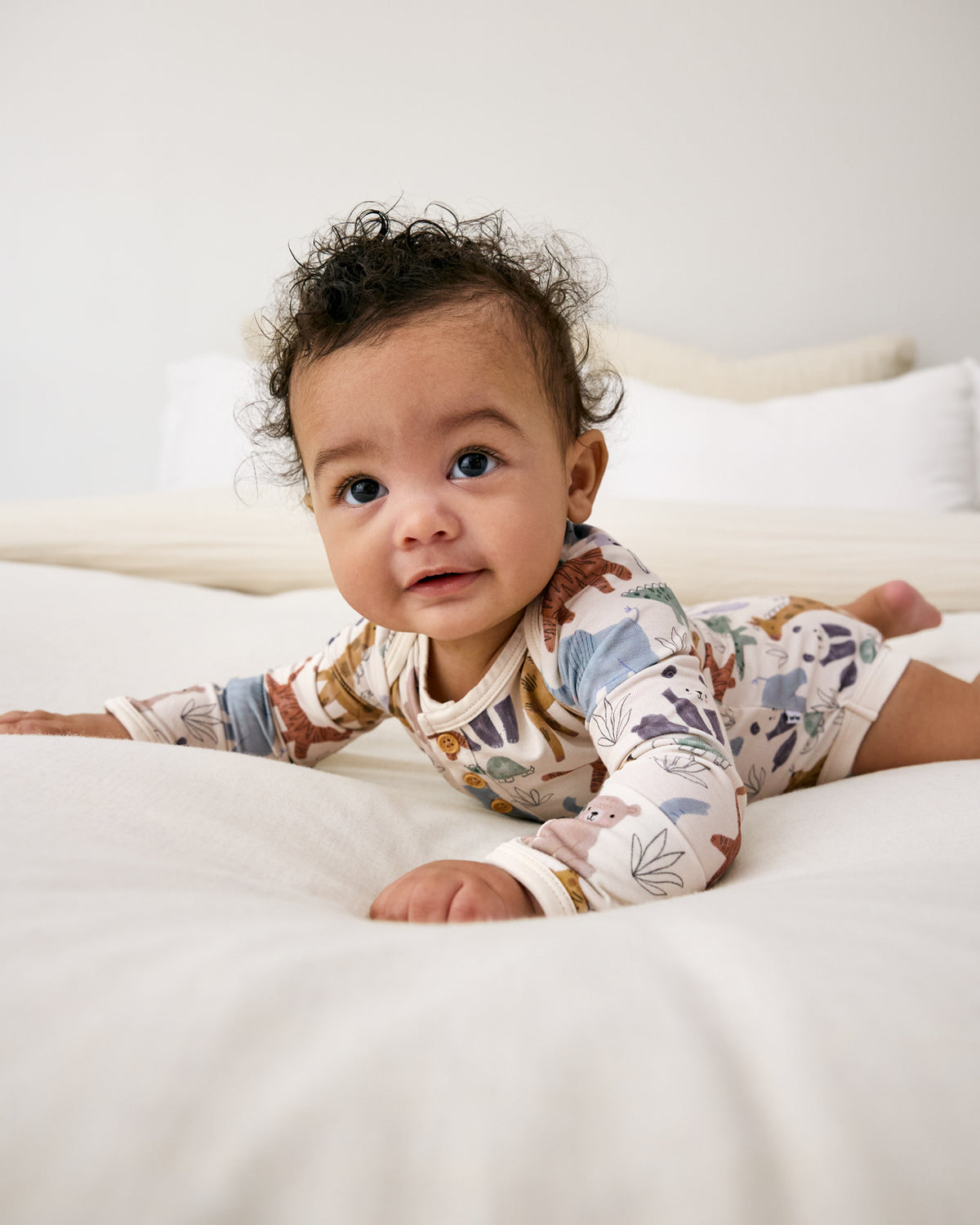 Baby laying on tummy wearing the Sweet Safari Henley Bodysuit