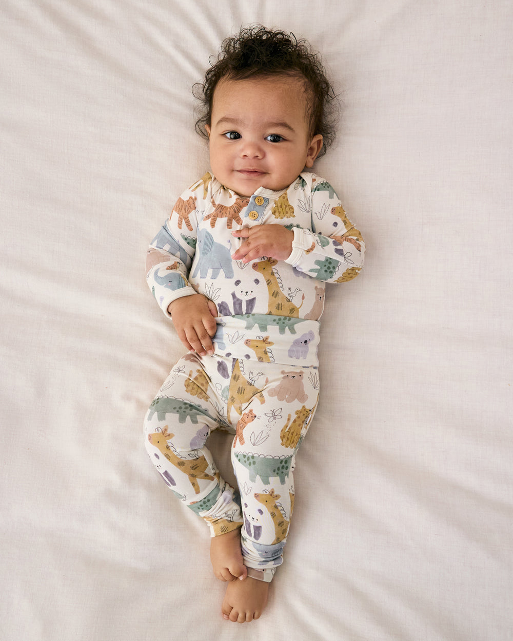 Aerial view of baby wearing the Sweet Safari Henley Bodysuit with coordinating newborn leggings